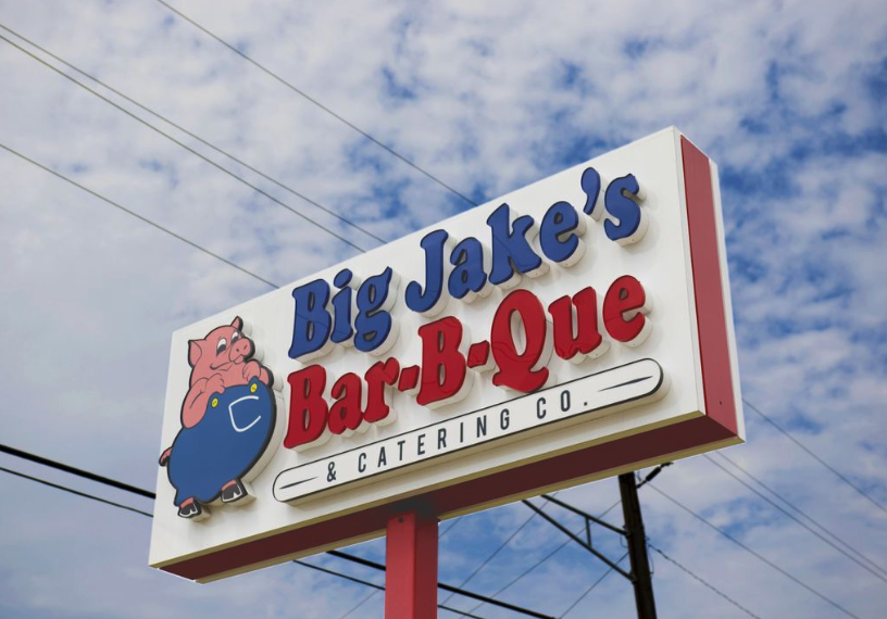 Face-lit channel letters mounted on a metal sign cabinet for Big Jake's Bar-B-Que in Texarkana, TX